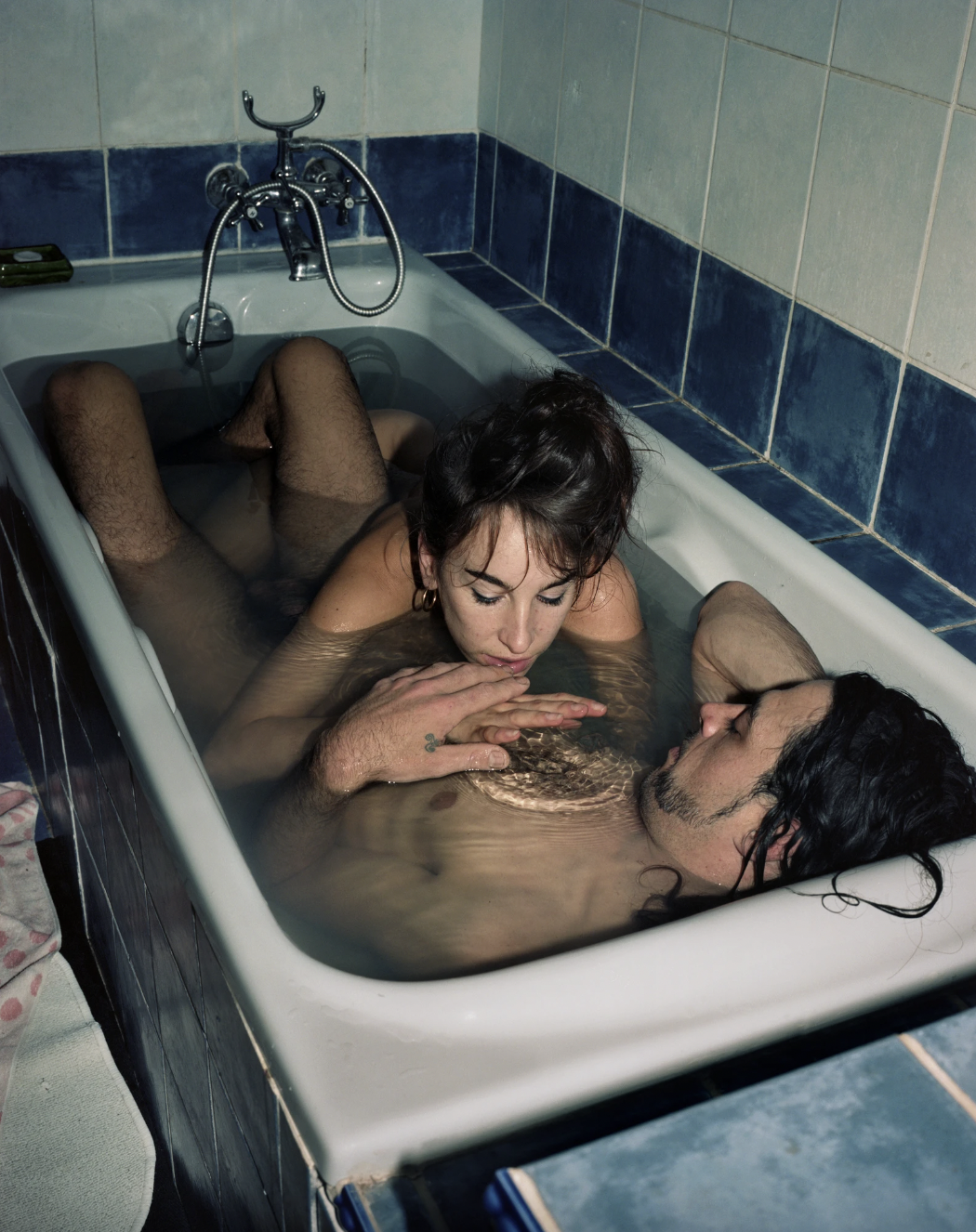 Photograph by Michella Bredahl of two people in a bathtub from the book 'Love Me Again'