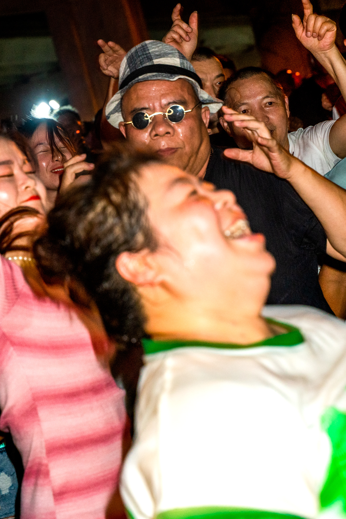 a blurred close up photo of older chinese people dancing happily