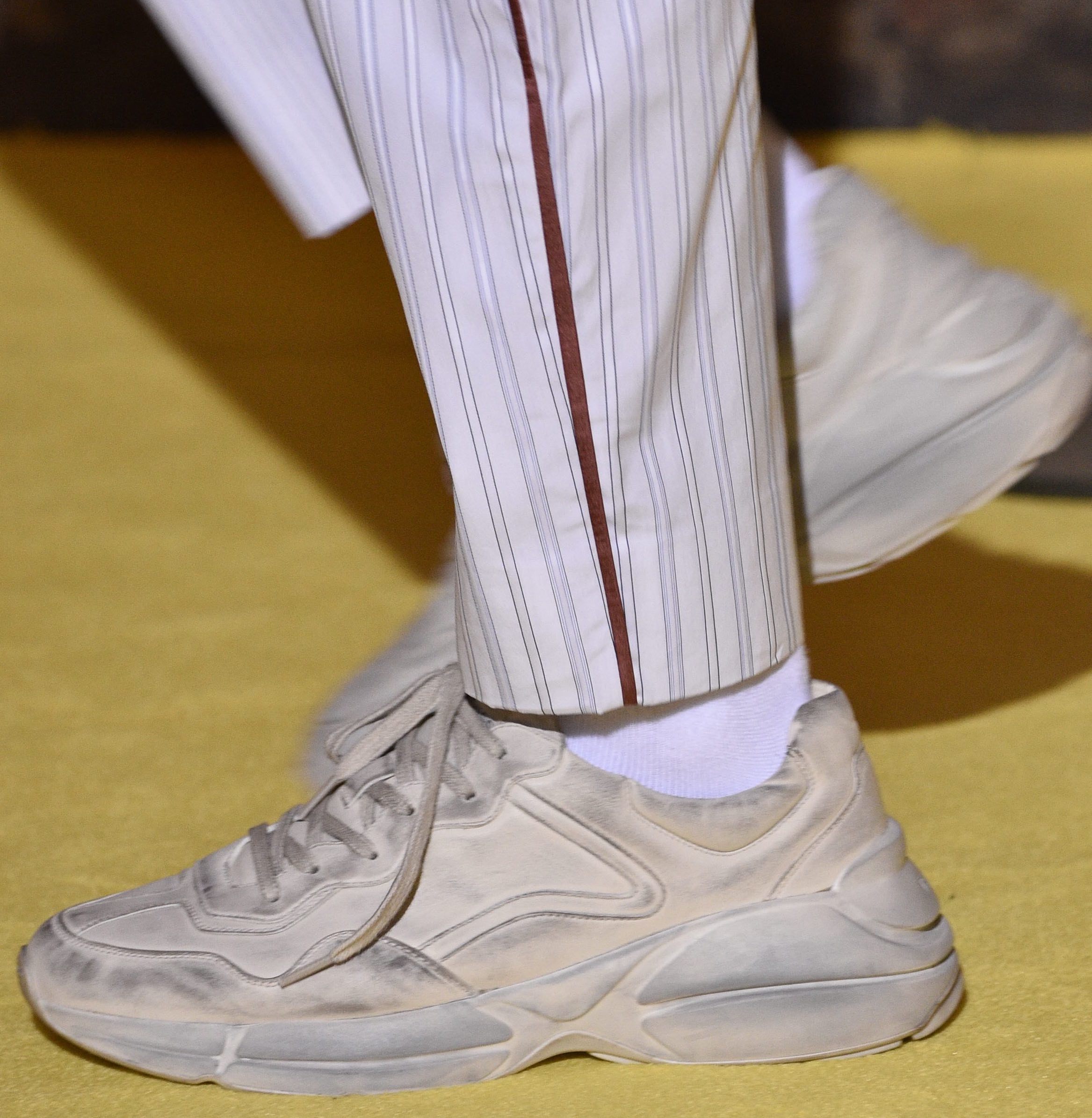 why designers are sending dirty sneakers down the runway