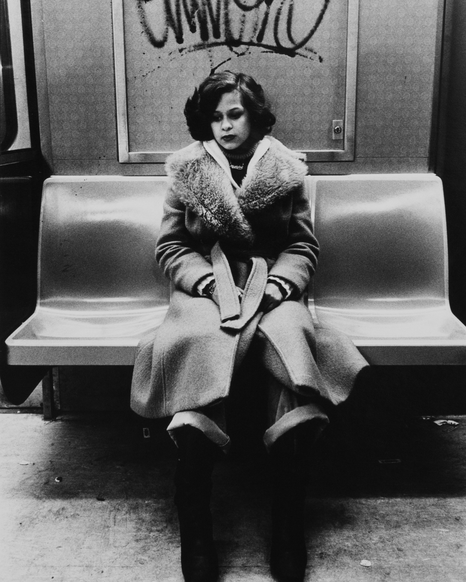 woman on new york subway dressed in a fur coat in a black and white photo by arlene gottfried 1980s