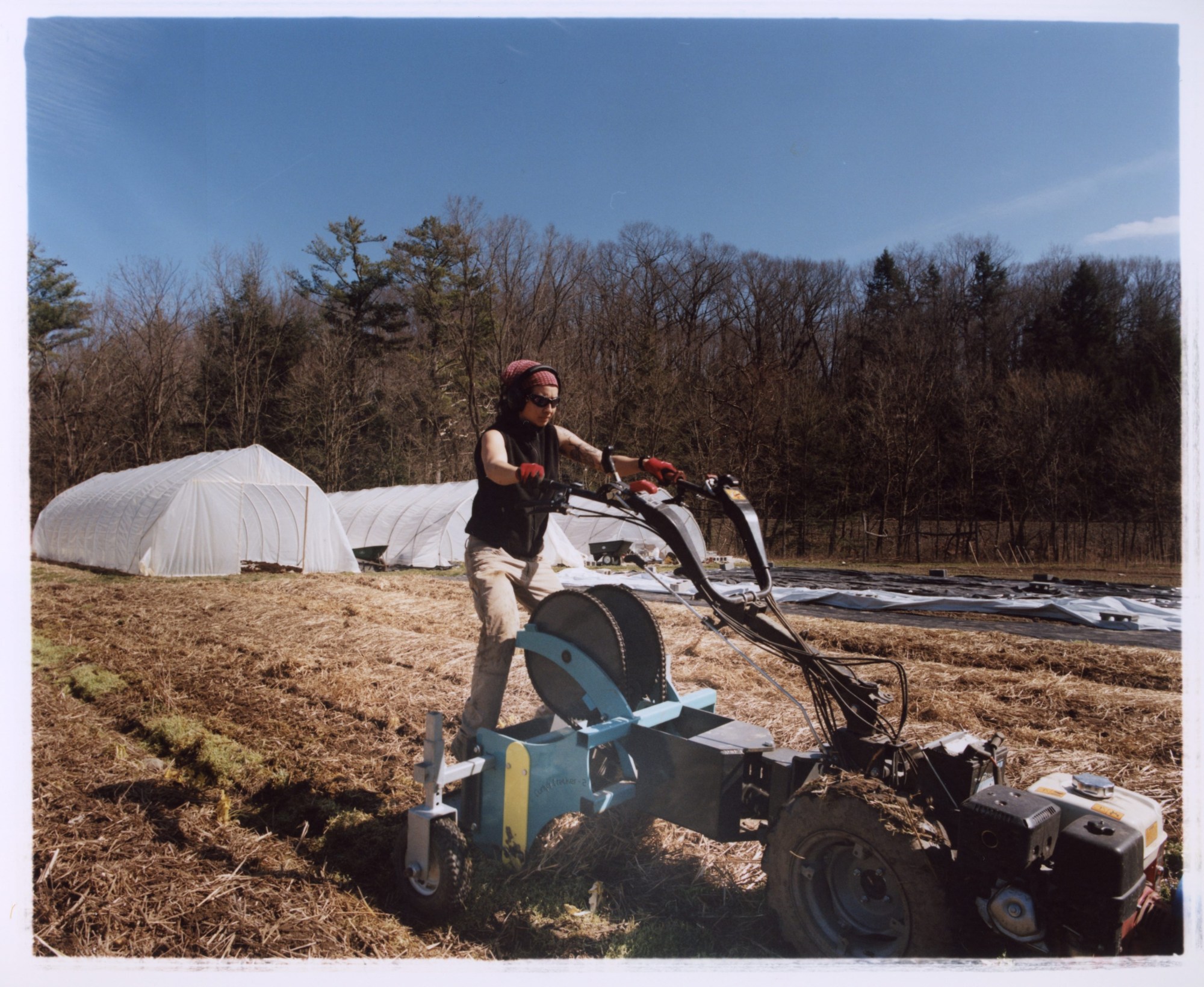 A farmer operates machinery in a field