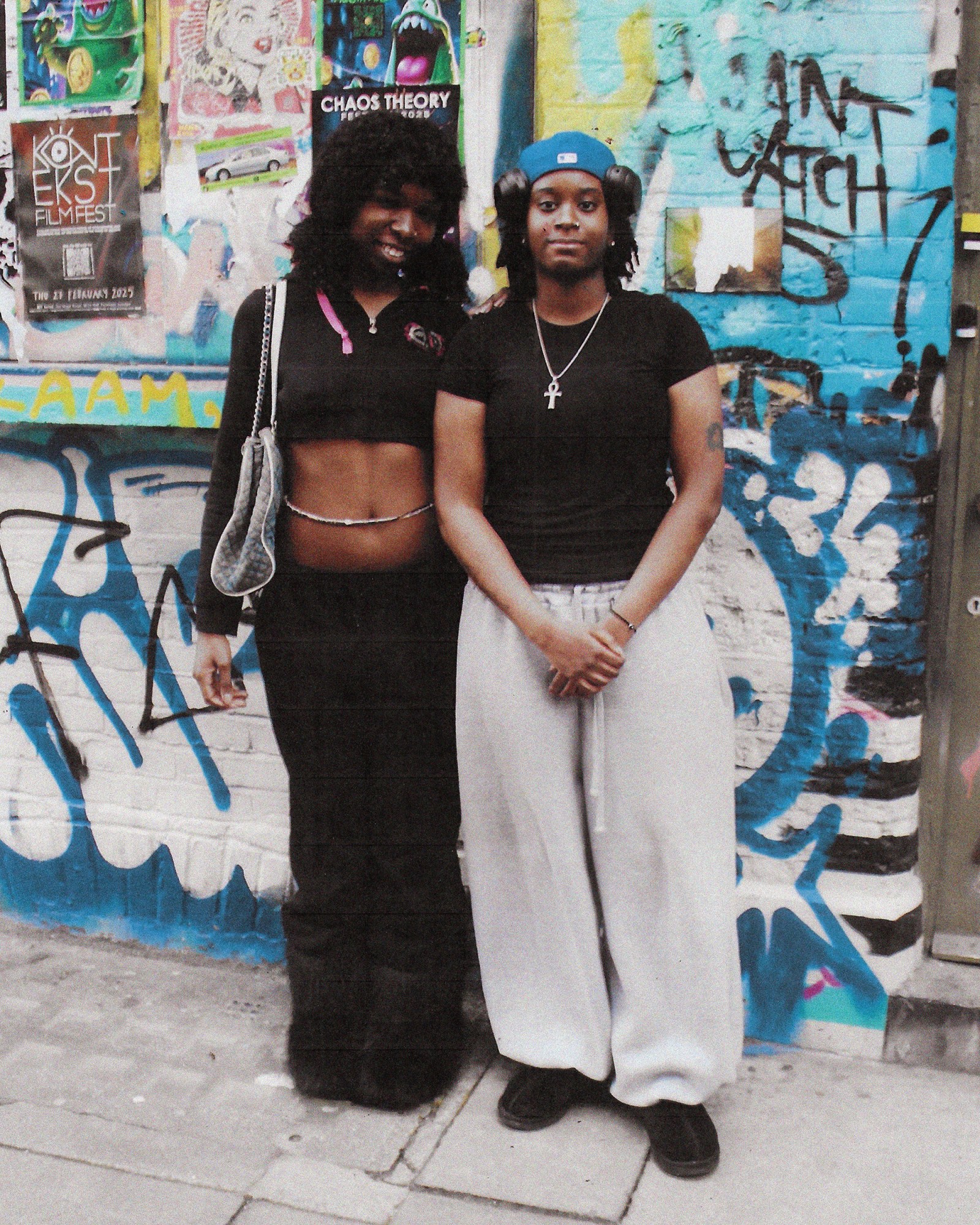 A full length photograph of two woman wearing black in London.