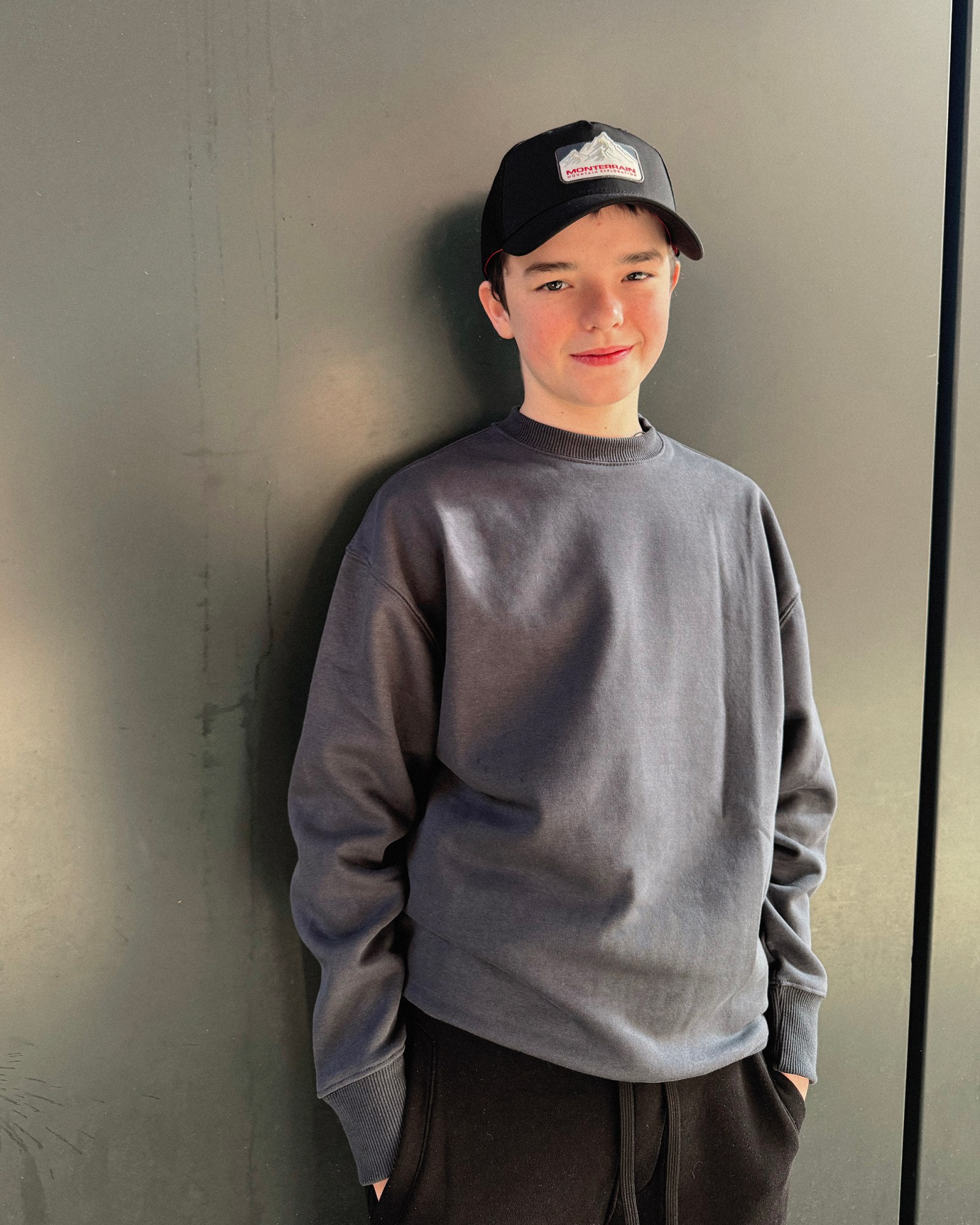 owen cooper adolescence actor netflix show wearing grey jumper and cap