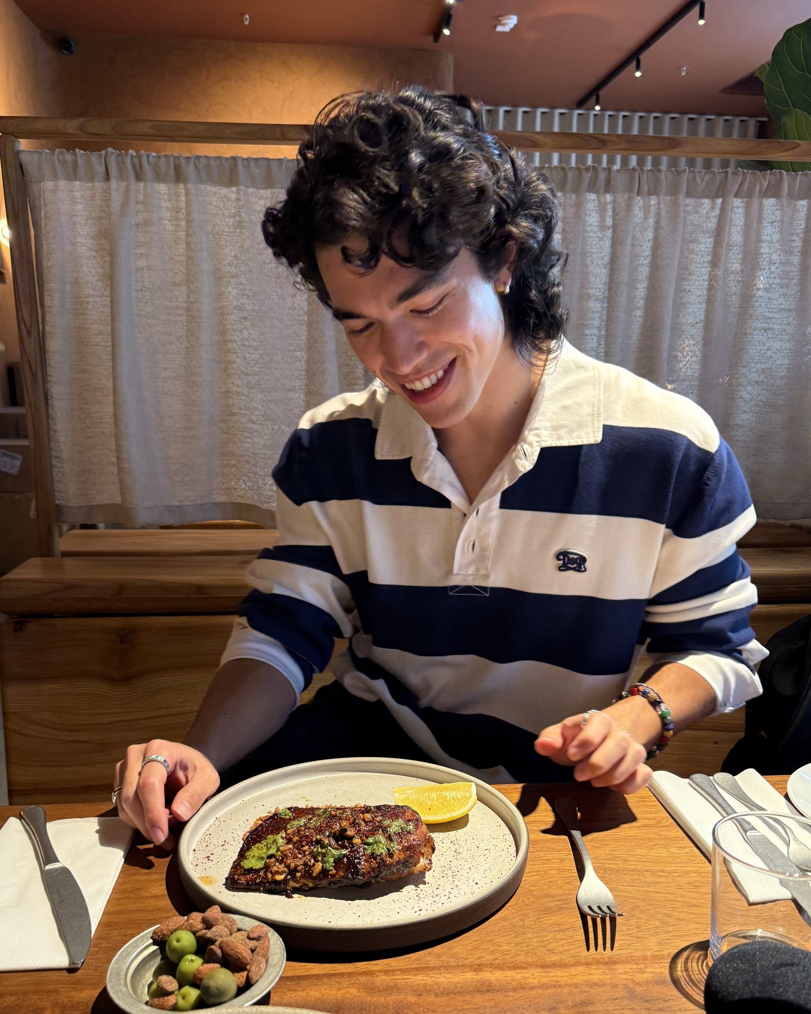 conan gray eating dinner at a restaurant