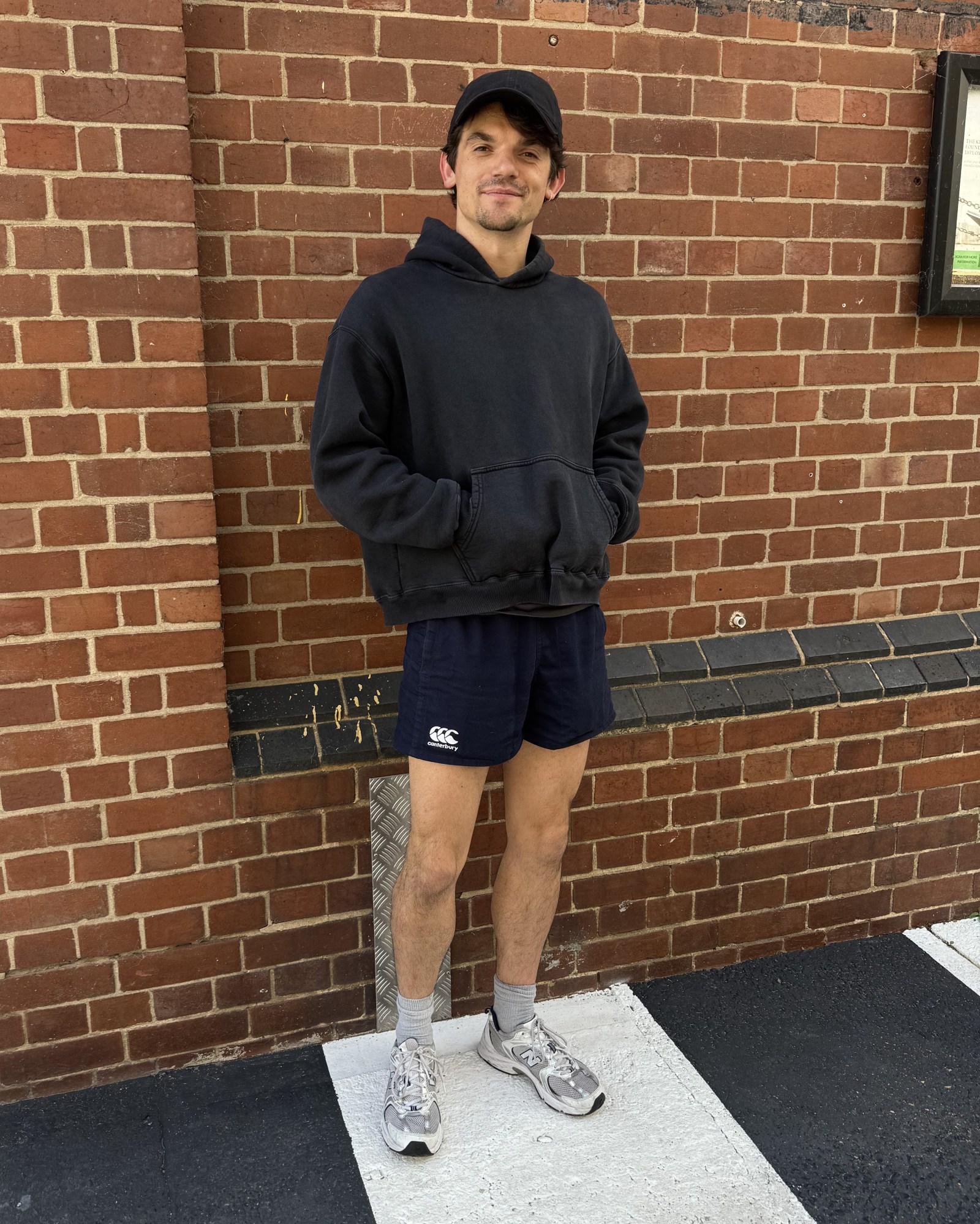 edward bluemel wearing a cap and hoodie and shorts 2025 for born with teeth press