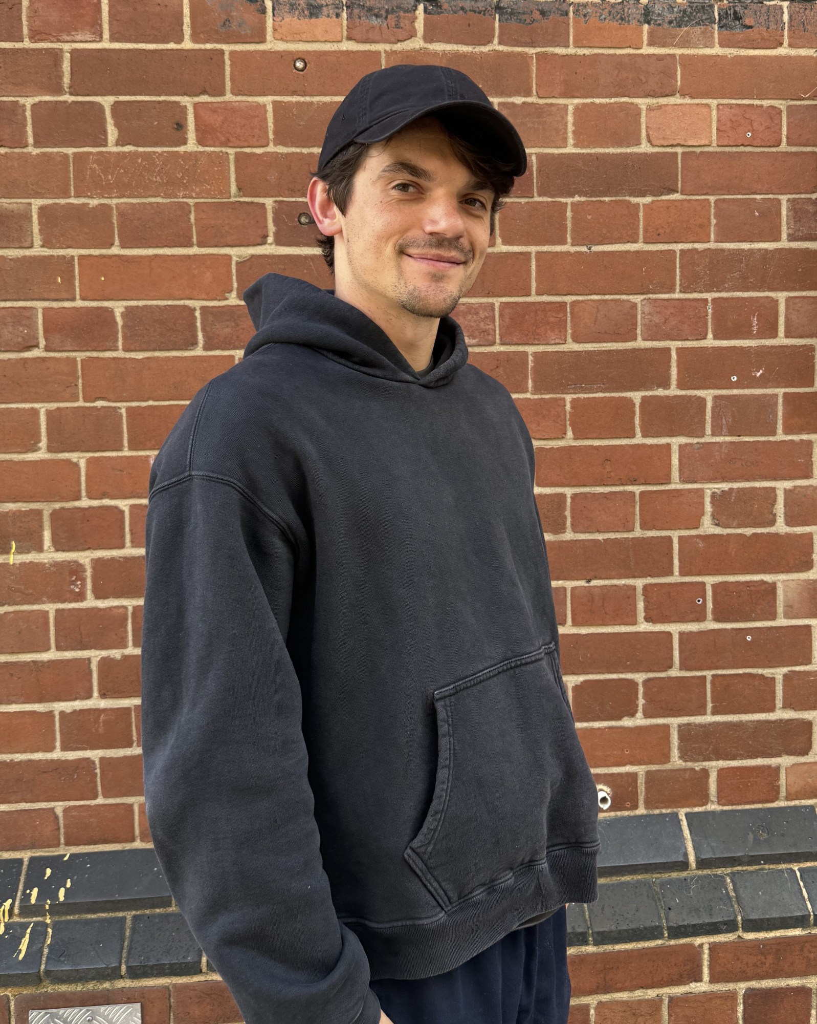 edward bluemel wearing a cap and hoodie 2025 for born with teeth press