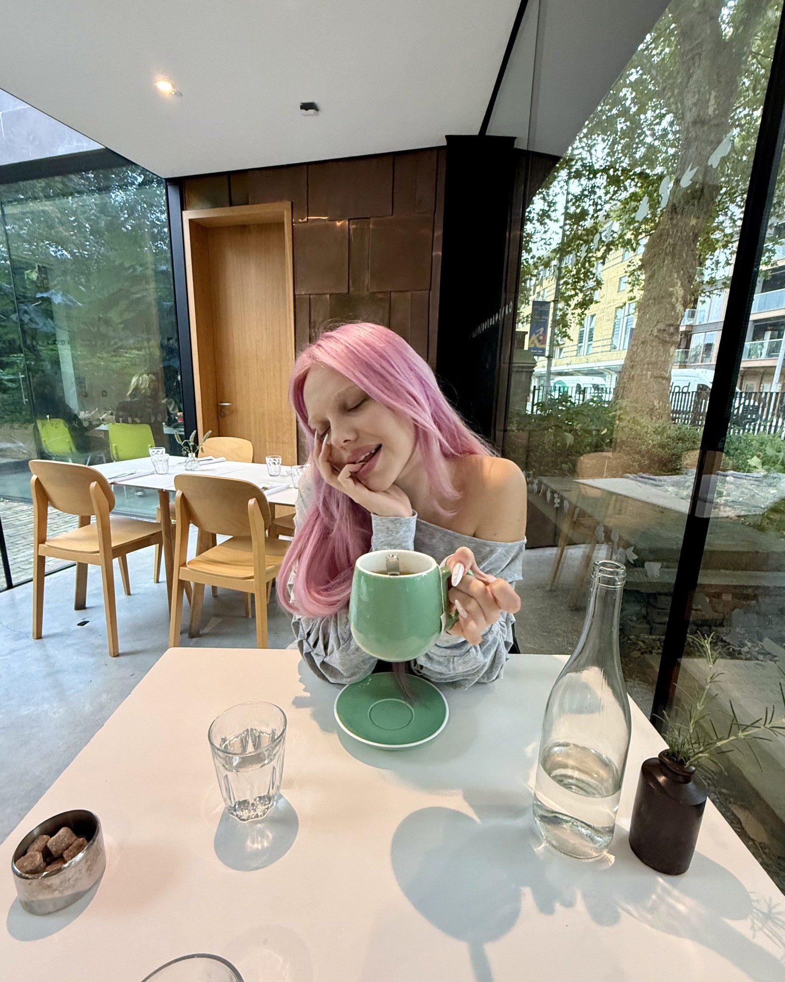 adela pop star pink hair photograph in cafe drinking tea