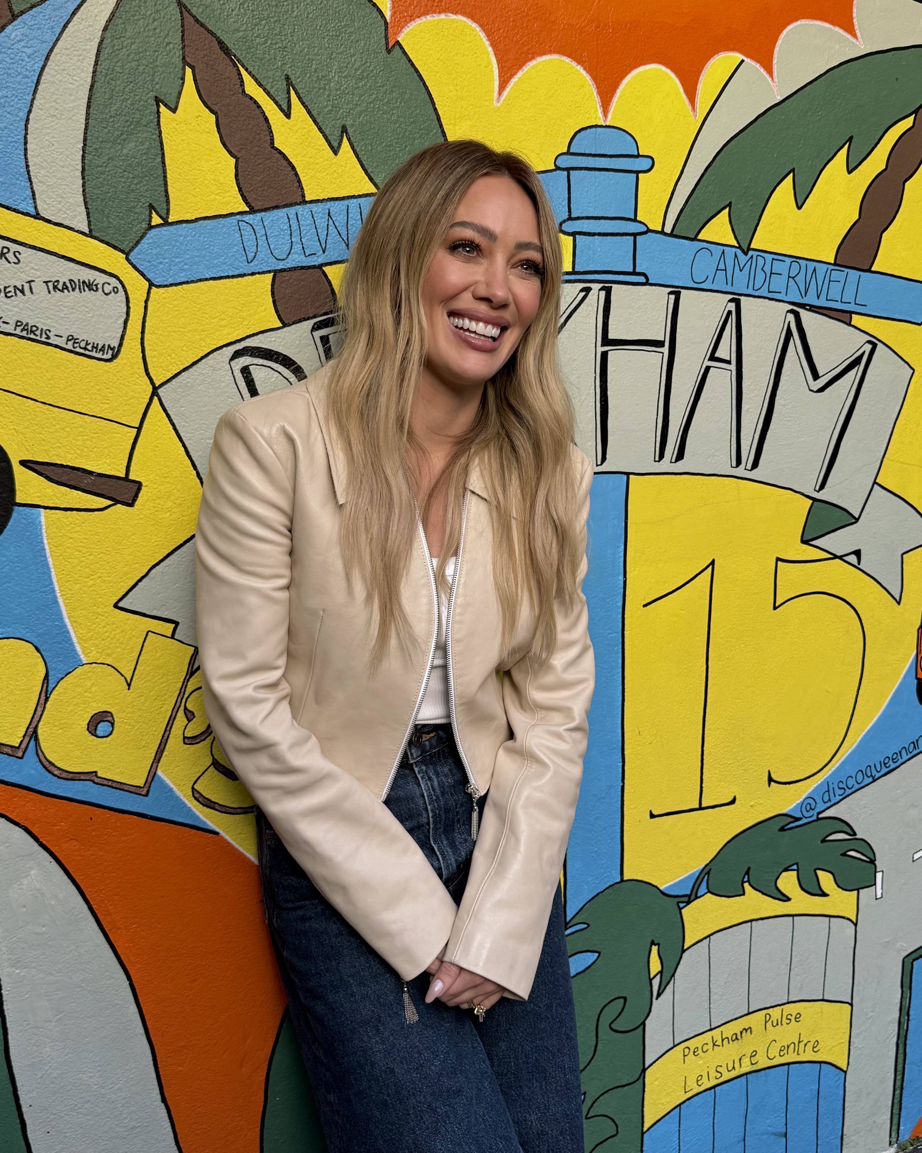 hilary duff pop star wearing a beige leather jacket